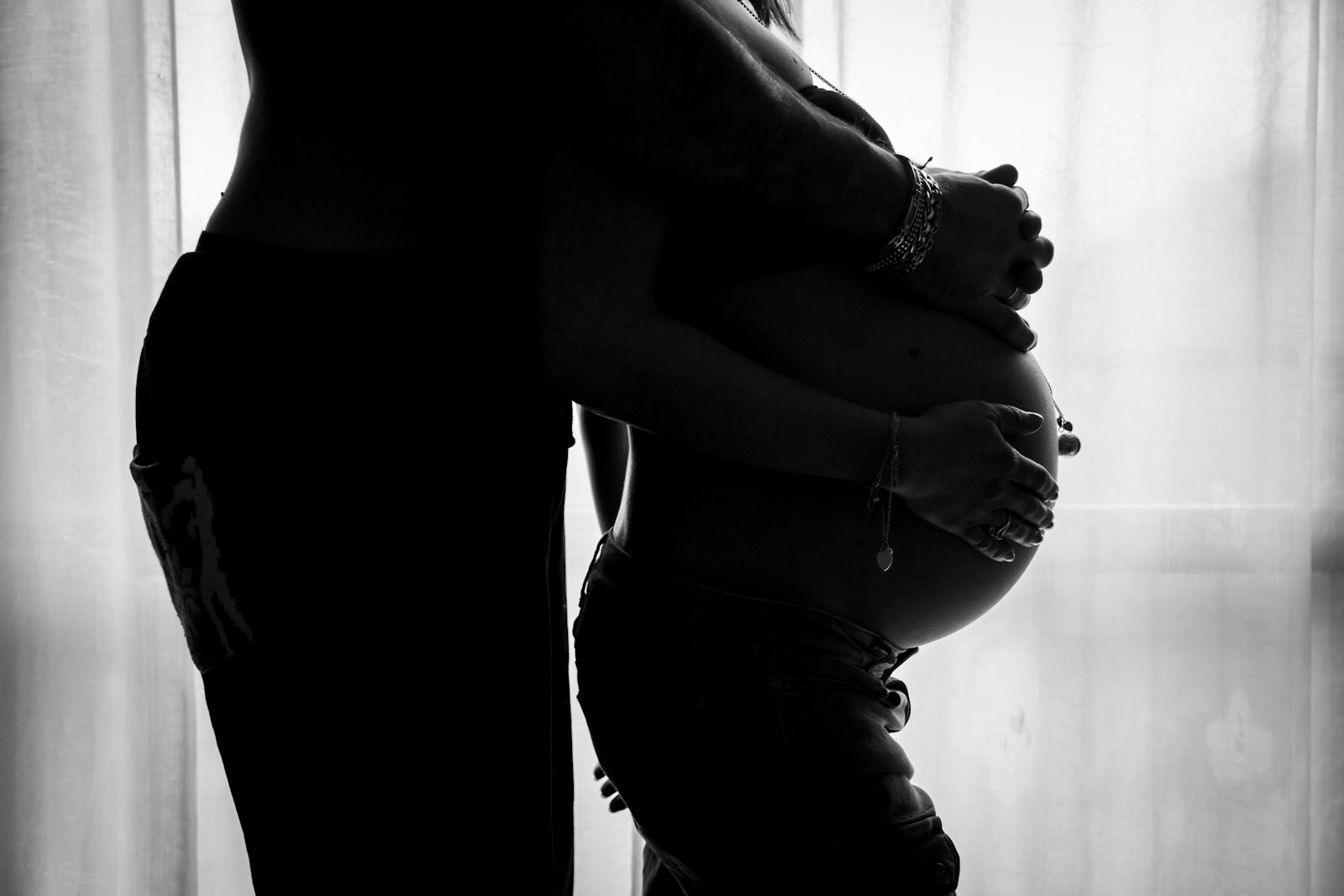 Photo by Andrea Bertozzini man holding woman tummy